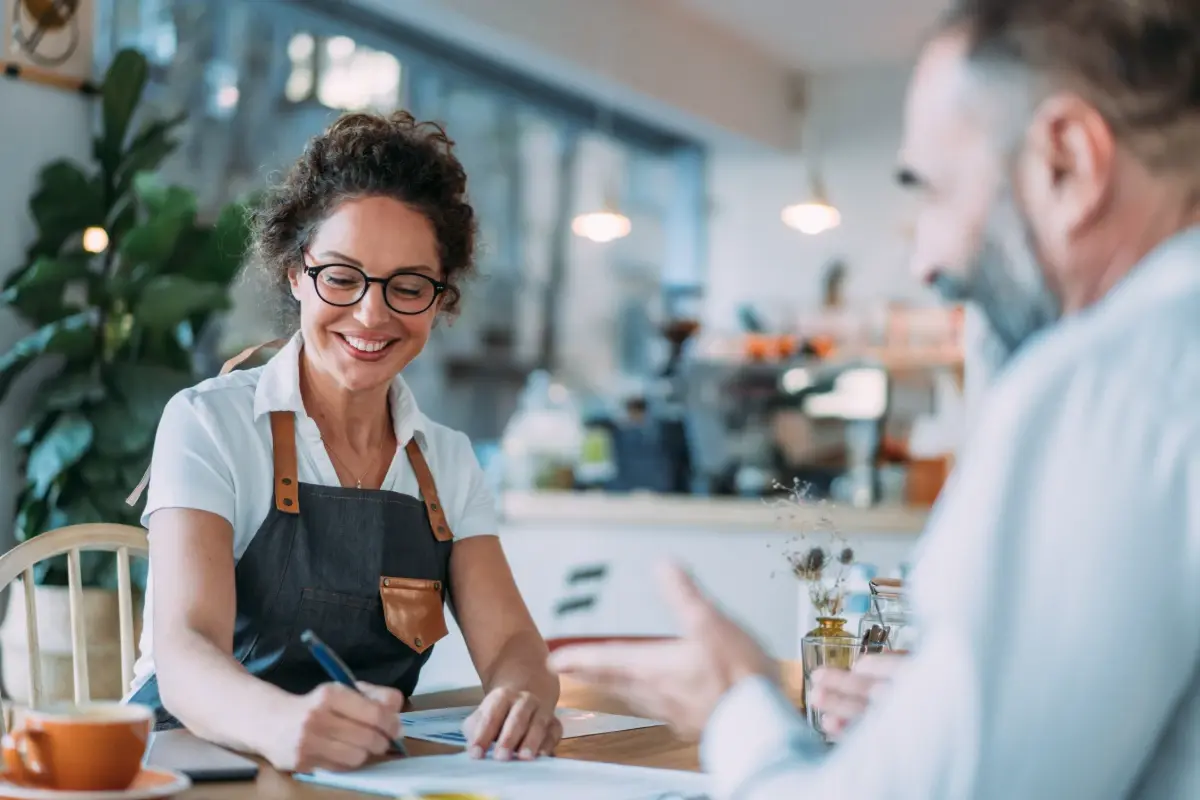 female-cafe-owner-signing-contract-meeting