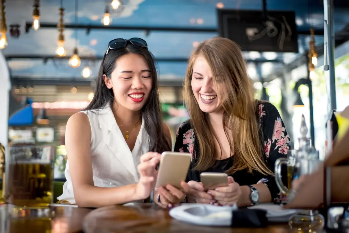 Young girls looking at their mobile devices